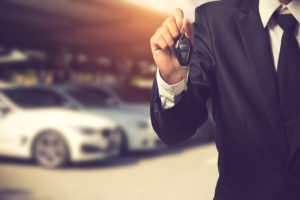 businessman showing car key